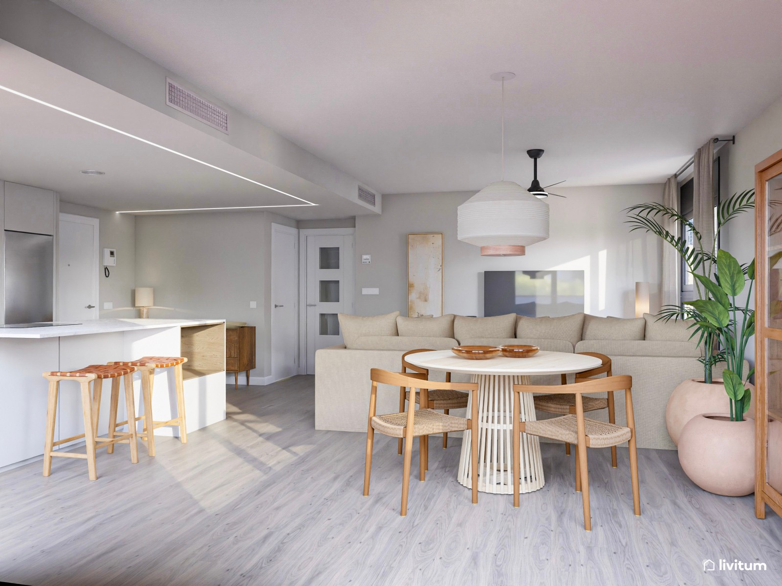 Acogedor salón con comedor redondo, cocina abierta y plantas decorativas