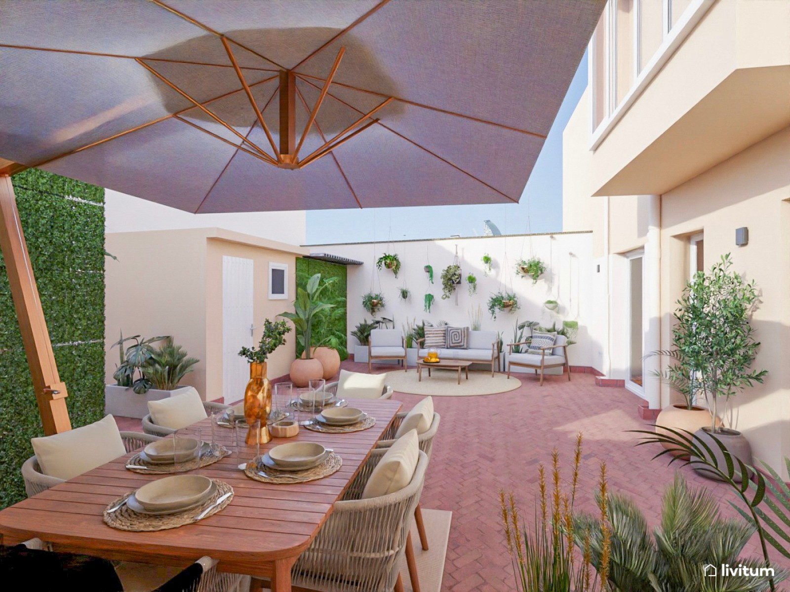 Amplia terraza con zona de relax y comedor repleta de plantas