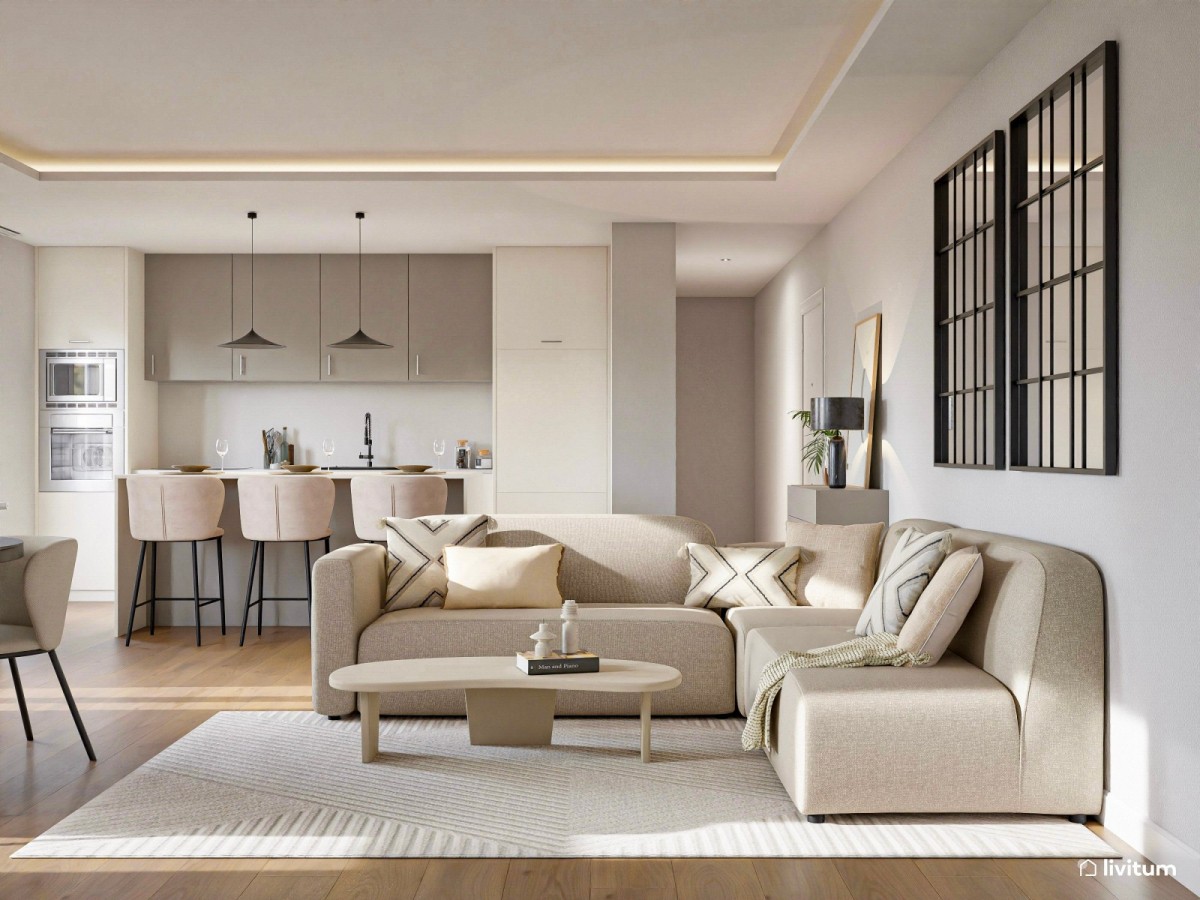 sal&oacute;n con cocina integrada en tonos neutros, sof&aacute; en L y mesa de centro