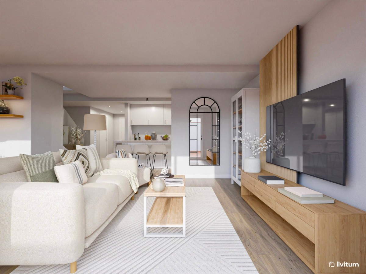 salón con cocina integrada en tonos claros, listones de madera, sofá y mesa de centro de madera